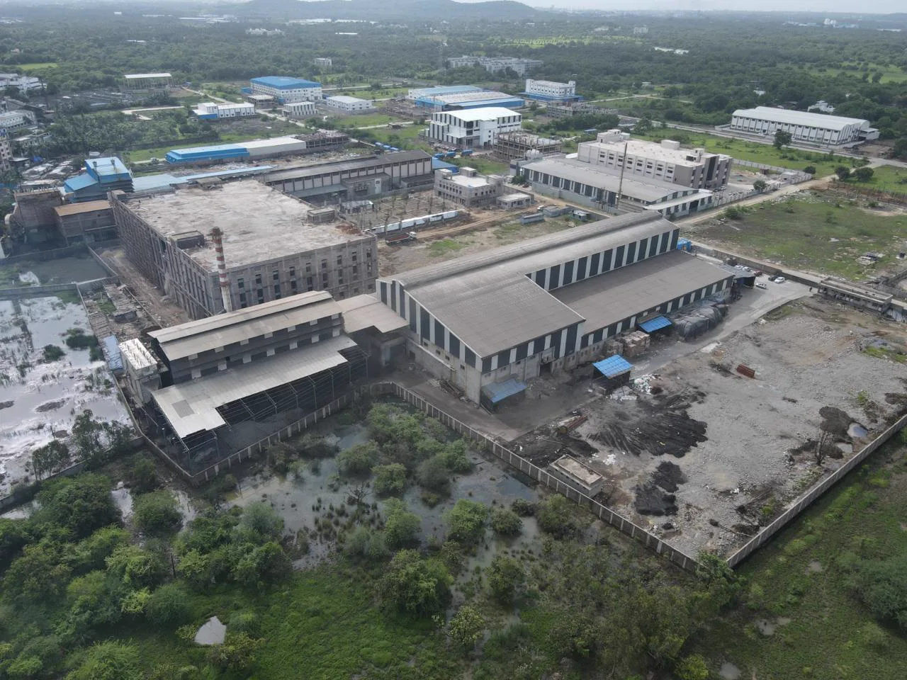Drone view of the plant among green fields near the Gujarat coast